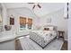 Cozy bedroom featuring a large window with views, a ceiling fan, and a comfortable bed setting at 318 Board Landing Circle, Conway, SC 29526