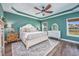 Spacious bedroom with a tray ceiling, ceiling fan, and large windows offering plenty of natural light at 318 Board Landing Circle, Conway, SC 29526