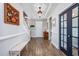 Bright entryway features wood floors, elegant wainscoting, and access to the upper level and main living areas at 318 Board Landing Circle, Conway, SC 29526