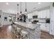Bright kitchen with white cabinetry, granite countertops, large island with seating, and stainless steel appliances at 318 Board Landing Circle, Conway, SC 29526