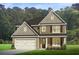 Charming two-story home with a landscaped yard, two-car garage, and wood-and-stone design accents at 338 Glacier Way, Conway, SC 29526