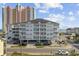 Low-angle view of a well-maintained condo with beach views in a coastal setting at 3401 Ocean Blvd. N # 103, North Myrtle Beach, SC 29582
