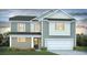 Charming two-story home featuring a two-car garage and beautifully landscaped front yard at 346 Glacier Way, Conway, SC 29526