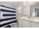 Cozy bathroom with a shower featuring a blue and white striped curtain, and tiled floors at 3704 Chapel Ln., Myrtle Beach, SC 29588