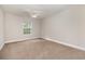 Spacious bedroom features carpet floors, a ceiling fan, and a window offering scenic views at 3704 Chapel Ln., Myrtle Beach, SC 29588
