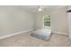 Neutral bedroom featuring carpet floors, a window overlooking nature, and space for relaxing at 3704 Chapel Ln., Myrtle Beach, SC 29588