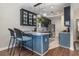 Stylish kitchen featuring dark cabinetry, modern pendant lighting, and a breakfast bar at 3704 Chapel Ln., Myrtle Beach, SC 29588