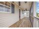 Covered porch featuring wood flooring, screen railing, and a ceiling fan, ideal for enjoying the outdoors at 3704 Chapel Ln., Myrtle Beach, SC 29588