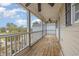 Covered porch with wood flooring, ceiling fans, and screened in railing, perfect for outdoor relaxation at 3704 Chapel Ln., Myrtle Beach, SC 29588