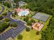 Aerial view of a community pool, tennis court, playground, and parking lot at 4025 Captiva Row, Myrtle Beach, SC 29579