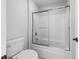 Bathroom with tub-shower featuring sliding glass doors and ceramic toilet at 4025 Captiva Row, Myrtle Beach, SC 29579