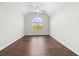 Bright bedroom with a ceiling fan, vaulted ceilings, large window, and hardwood floors at 4025 Captiva Row, Myrtle Beach, SC 29579