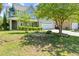 Beautiful landscaped front yard with a stone garden surrounding a majestic tree and leading to the house at 4025 Captiva Row, Myrtle Beach, SC 29579