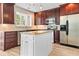 Spacious kitchen featuring stainless steel appliances, granite countertops, and a center island at 4025 Captiva Row, Myrtle Beach, SC 29579