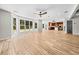 Bright living room with expansive windows, a ceiling fan, and wood-look tile floors at 4025 Captiva Row, Myrtle Beach, SC 29579