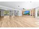 Open-concept living room with a stone fireplace, built-in shelving, and wood-look tile flooring at 4025 Captiva Row, Myrtle Beach, SC 29579