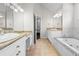 Main bathroom featuring double sinks, bathtub, and tile flooring at 4025 Captiva Row, Myrtle Beach, SC 29579