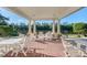 Inviting covered patio with brick flooring, white columns, and ample seating at 4025 Captiva Row, Myrtle Beach, SC 29579