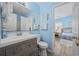 Bathroom with modern vanity, toilet, and partial view into the adjacent bedroom at 412 Seaside Dr. S, Surfside Beach, SC 29575