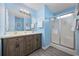 Bathroom with double sink vanity, a large mirror and a glass-enclosed shower at 412 Seaside Dr. S, Surfside Beach, SC 29575