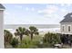 Tranquil view of the beach and palm trees from a beach house at 412 Seaside Dr. S, Surfside Beach, SC 29575