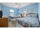 Bedroom featuring two beds, wood-look floors, a ceiling fan, and natural light from the windows at 412 Seaside Dr. S, Surfside Beach, SC 29575