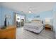 Bright bedroom with a queen bed and sliding door to a balcony at 412 Seaside Dr. S, Surfside Beach, SC 29575