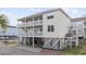 Beautiful elevated beach home with white railings and ground-level parking at 412 Seaside Dr. S, Surfside Beach, SC 29575