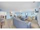 Open concept living room and dining room with blue walls and wood-look floors at 412 Seaside Dr. S, Surfside Beach, SC 29575