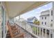 Relaxing porch with wooden rocking chairs and views of neighborhood homes at 412 Seaside Dr. S, Surfside Beach, SC 29575
