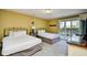 Comfortable bedroom featuring two beds, balcony access, and stylish decor offering a relaxing retreat at 4850 Cantor Ct. # 202, North Myrtle Beach, SC 29582