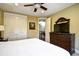 Spacious bedroom featuring a ceiling fan, large dresser, and an open doorway to the adjoining living area at 4850 Cantor Ct. # 202, North Myrtle Beach, SC 29582