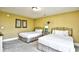 Cozy bedroom with two beds, soft lighting, and tasteful decorations creating a warm and inviting atmosphere at 4850 Cantor Ct. # 202, North Myrtle Beach, SC 29582