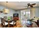 Open-concept dining area with a stylish light fixture and sliding glass doors leading to an outdoor balcony at 4850 Cantor Ct. # 202, North Myrtle Beach, SC 29582