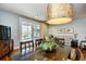 Bright dining area features a modern light fixture and a sliding glass door opening to a balcony at 4850 Cantor Ct. # 202, North Myrtle Beach, SC 29582
