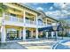 Elegant building with covered walkways, ceiling fans, large windows, and awning at 21 Main at North Beach at 4850 Cantor Ct. # 202, North Myrtle Beach, SC 29582