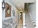 Inviting foyer with tiled flooring, a staircase, and a decorative mirror creating a warm and stylish entrance to the home at 4850 Cantor Ct. # 202, North Myrtle Beach, SC 29582