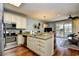 Open kitchen with stainless appliances, granite counters, and a breakfast bar overlooking the dining area at 4850 Cantor Ct. # 202, North Myrtle Beach, SC 29582