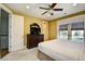 Bright main bedroom features a ceiling fan, large dresser with television, and a window with woven shades at 4850 Cantor Ct. # 202, North Myrtle Beach, SC 29582
