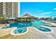 Resort pool with in-water seating, a swim-up bar, and cascading waterfalls, perfect for relaxation and enjoyment at 4850 Cantor Ct. # 202, North Myrtle Beach, SC 29582
