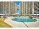 Stunning pool area surrounded by high-rise buildings with cabanas and sun loungers for ultimate relaxation at 4850 Cantor Ct. # 202, North Myrtle Beach, SC 29582