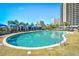 Outdoor pool area with sun loungers and umbrellas, offering a perfect spot to unwind and enjoy the view at 4850 Cantor Ct. # 202, North Myrtle Beach, SC 29582