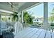 White Adirondack chairs on a covered porch with neighborhood view, providing a comfortable place to relax at 4850 Cantor Ct. # 202, North Myrtle Beach, SC 29582