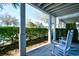 Cozy porch with white rocking chairs and lush green landscaping, perfect for relaxing outdoors at 4850 Cantor Ct. # 202, North Myrtle Beach, SC 29582