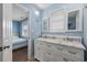 Well-lit bathroom with a double sink vanity and a separate doorway to a bedroom at 510 S Ocean Blvd., Surfside Beach, SC 29575