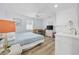 Well-lit bedroom with a large window, neutral walls, desk, and ensuite bathroom at 510 S Ocean Blvd., Surfside Beach, SC 29575