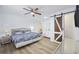 Bedroom with a floral-patterned bedspread, modern ceiling fan, and sliding barn door to the bathroom at 510 S Ocean Blvd., Surfside Beach, SC 29575