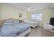 Bright bedroom featuring two beds, ceiling fan, neutral walls, and a window at 510 S Ocean Blvd., Surfside Beach, SC 29575