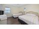 Well-lit bedroom features two beds, a ceiling fan, and a side table at 510 S Ocean Blvd., Surfside Beach, SC 29575