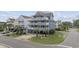 Stunning three-story beach house with multiple decks, palm trees, and ocean views, perfect for coastal living at 510 S Ocean Blvd., Surfside Beach, SC 29575